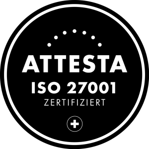 A black, circular badge with white lettering bears the inscription "ATTESTA ISO 27001 CERTIFIED," which signifies MaxBrain certification, and features a dotted arc at the top and a plus sign inside a smaller circle at the bottom.