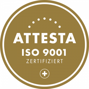 A circular gold plaque with white text reading "ATTTESTA ISO 9001 CERTIFIED" and a small white plus sign at the bottom, surrounded by white dots and a two-line border—perfect for showcasing the MaxBrain certification.